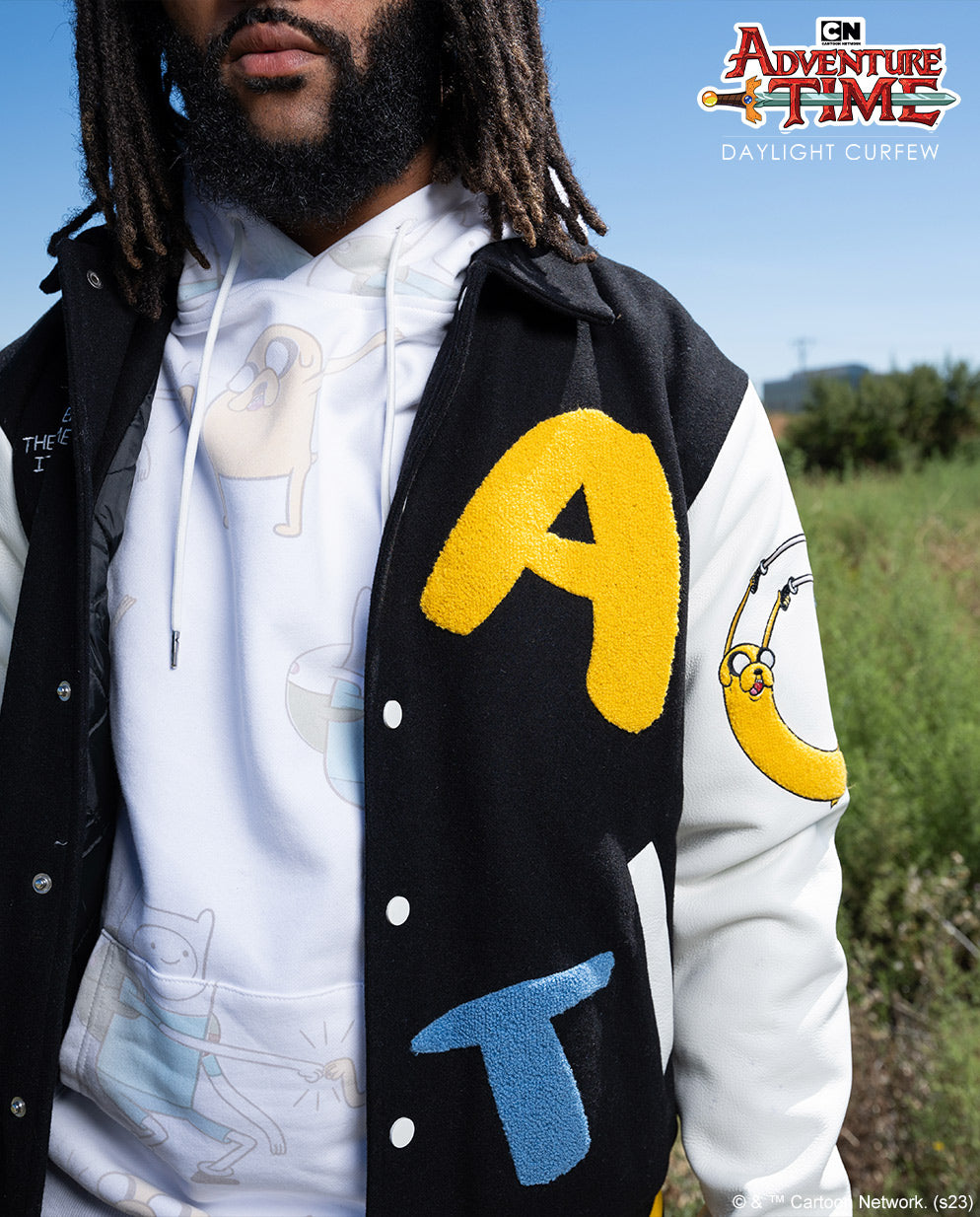 Collectors Edition varsity jacket layered over a hoodie in original outdoor photography