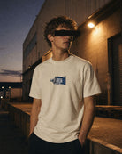 DLC Paint Tube Tee Ivory worn at a loading dock